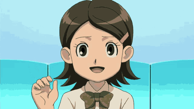 a girl with brown hair and a green bow tie is smiling