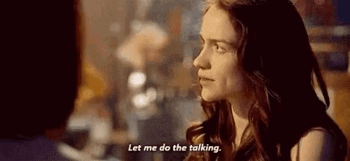 a woman is talking to a man and says `` let me do the talking . ''