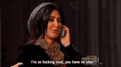 a woman is crying and talking on a cell phone .