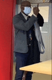 a man wearing a mask is holding a rope in his hands .