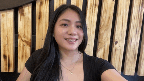 a woman with braces on her teeth is smiling
