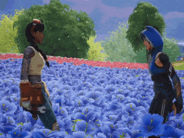 two women are standing in a field of blue flowers talking to each other
