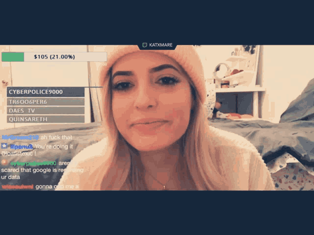 a woman wearing a pink beanie is on a computer screen with katymare at the top of the screen