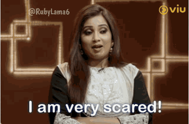 a woman says i am very scared in front of a brown background