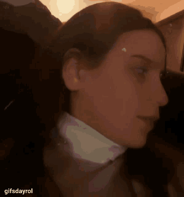 a close up of a woman 's face with a collar on her neck .