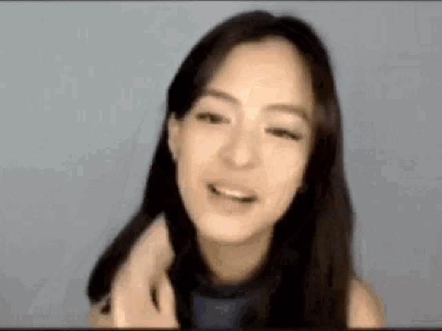 a close up of a woman 's face with a blurred background .