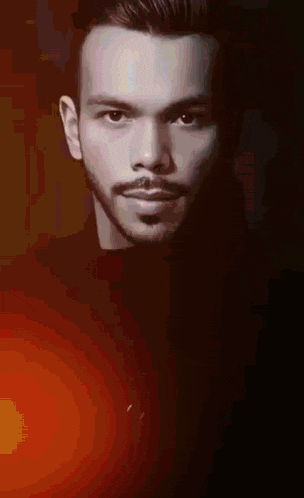 a man with a beard and mustache is wearing a black turtleneck