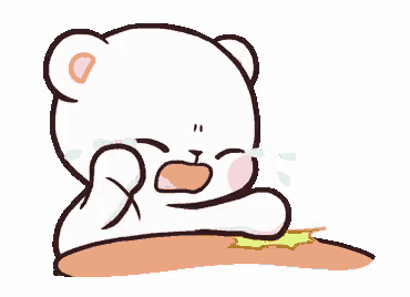 a cartoon teddy bear is crying while sitting on a table .