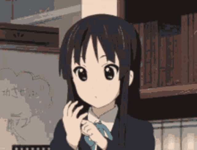 a girl with long black hair is standing in front of a bookshelf and a chalkboard