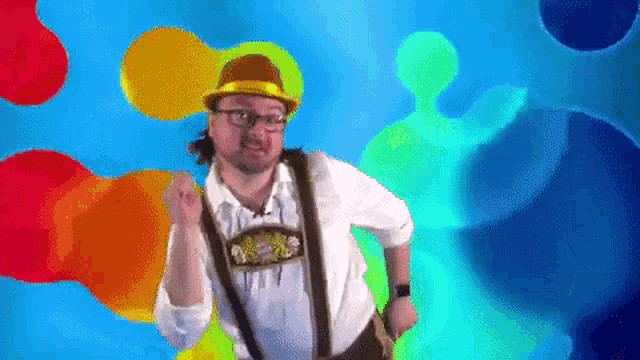 a man wearing a hat and suspenders is dancing