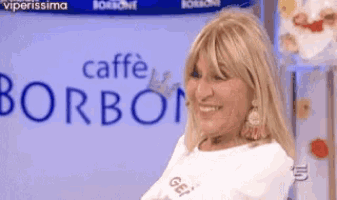 a woman smiles in front of a sign that says caffe borboni