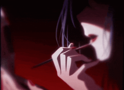 a woman with red nails is applying lipstick with a brush
