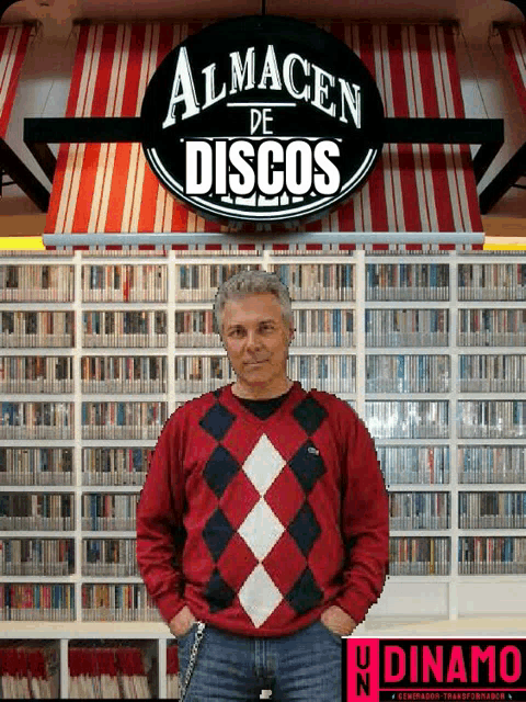a man in a red sweater stands in front of a sign that says almacen de discos