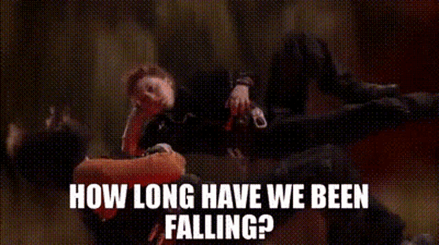 a woman in a witch costume is dancing on a stage and says `` how long have we been falling ? ''