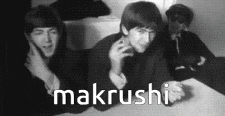 a black and white photo of three men sitting at a table with the word makrushi written in white letters .