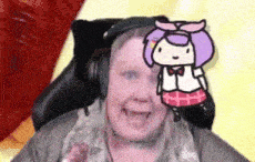 a woman wearing headphones is sitting in a chair with a cartoon girl on her face .