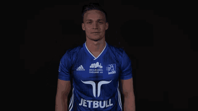 a man wearing a blue jersey that says jetbull on the front