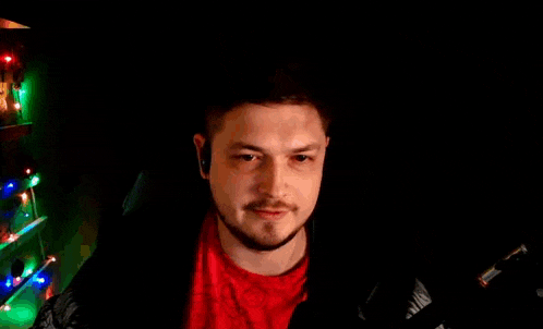 a man wearing headphones is standing in a dark room .