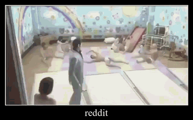 a man is standing in a room with a lot of children playing .