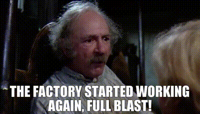 a man with gray hair and a mustache is sitting in a rocking chair with the words the factory started working again full blast .