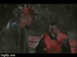 a man in a red jacket is talking to another man in a black jacket .