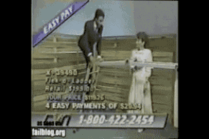 a man in a suit and tie is standing next to a woman holding a piece of wood