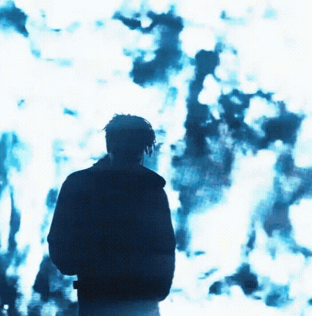 a person standing in front of a blue background