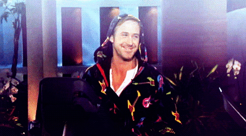a man wearing a hooded robe is smiling in a room .