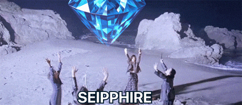 a group of people are standing in front of a large diamond that says seipphire on it