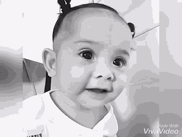 a black and white photo of a baby with the words made with vivavideo on the bottom
