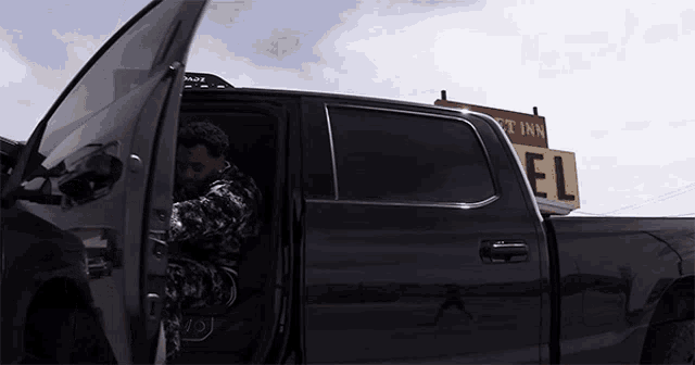 a man is getting out of a truck with a sign that says el on it