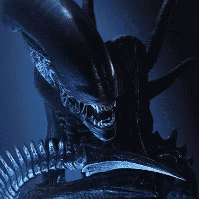 a close up of an alien with its mouth open and sharp claws