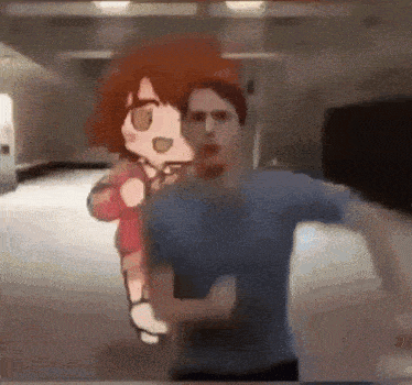 a man in a blue shirt is standing in front of a cartoon character