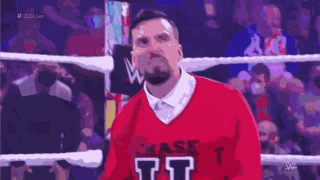 a man wearing a red sweater that says chase it