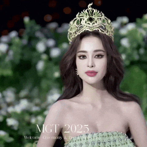 a woman wearing a green dress and a gold crown stands in front of a sign that says mgt 2025