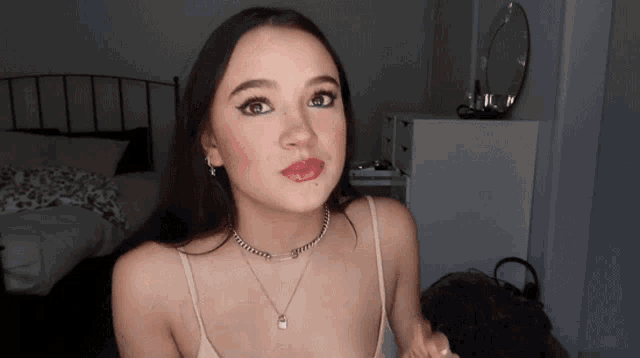 a woman wearing a necklace that says ' i 'm sorry ' on it
