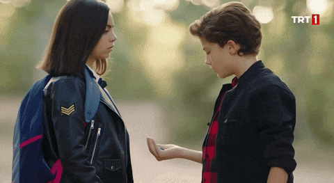 a boy and a girl are standing next to each other with trt1 written on the bottom of the screen