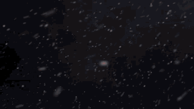 a red butterfly is flying through a snowy sky