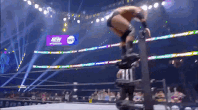 a man in a wrestling ring with a tnt sign in the background