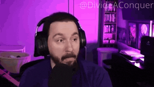a man wearing headphones is sitting in front of a microphone with the words divide aconquer written in the corner
