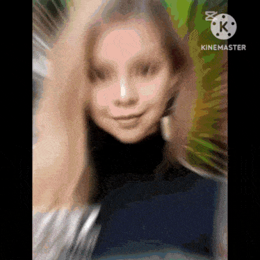 a blurry picture of a woman 's face with the letter k on the bottom