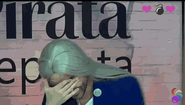 a woman covering her face with her hand in front of a sign that says rata
