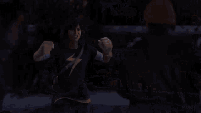 a blurry picture of two people fighting in a dark room