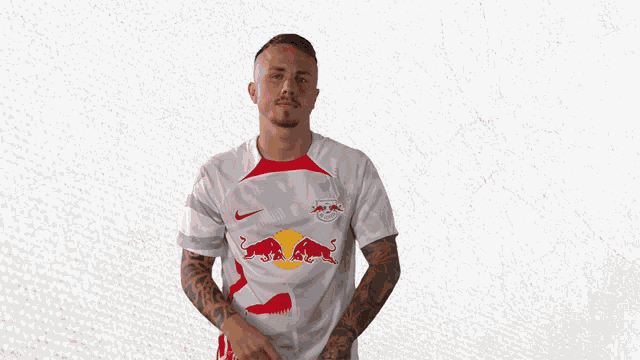 a man is wearing a white shirt with red bulls on it
