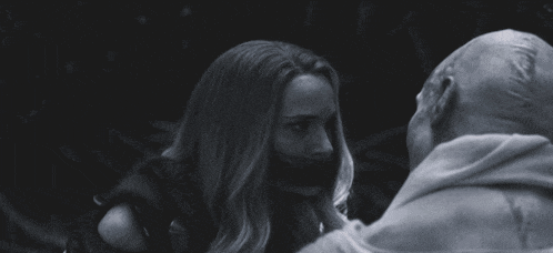 a black and white photo of a woman and a man with bandages on their faces