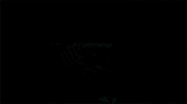 a close up of a person playing a guitar in the dark