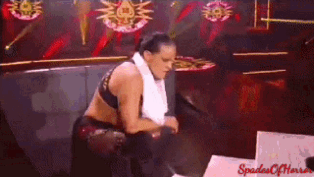 a woman is sitting on a couch with a towel around her neck and the words spades of horror on the bottom
