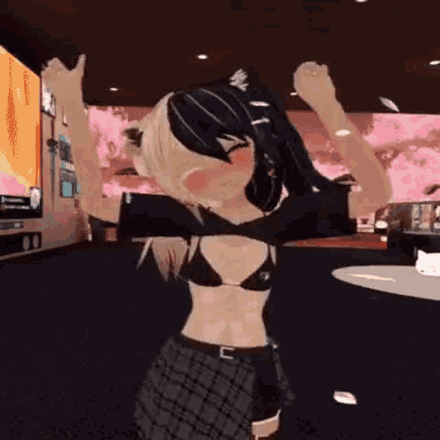 a girl in a bikini and plaid skirt is dancing in a room with her arms in the air .