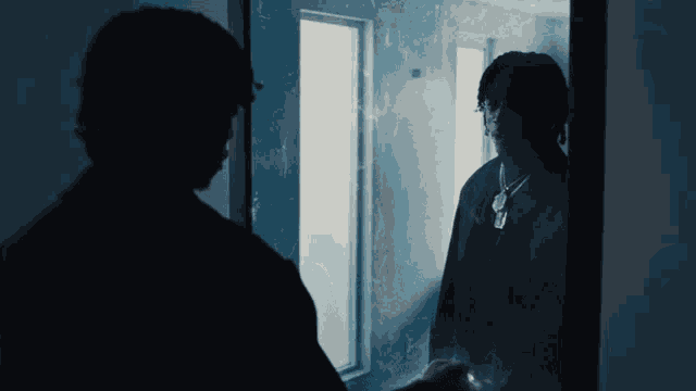 a man standing in front of a door looking at himself