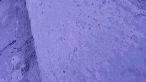 a person 's feet are shown in a blurry photo while standing on a white surface .